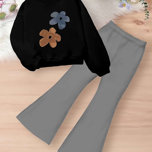 Trendy two-piece set for girls featuring a floral top with cartoon applique, ideal for fall and winter.