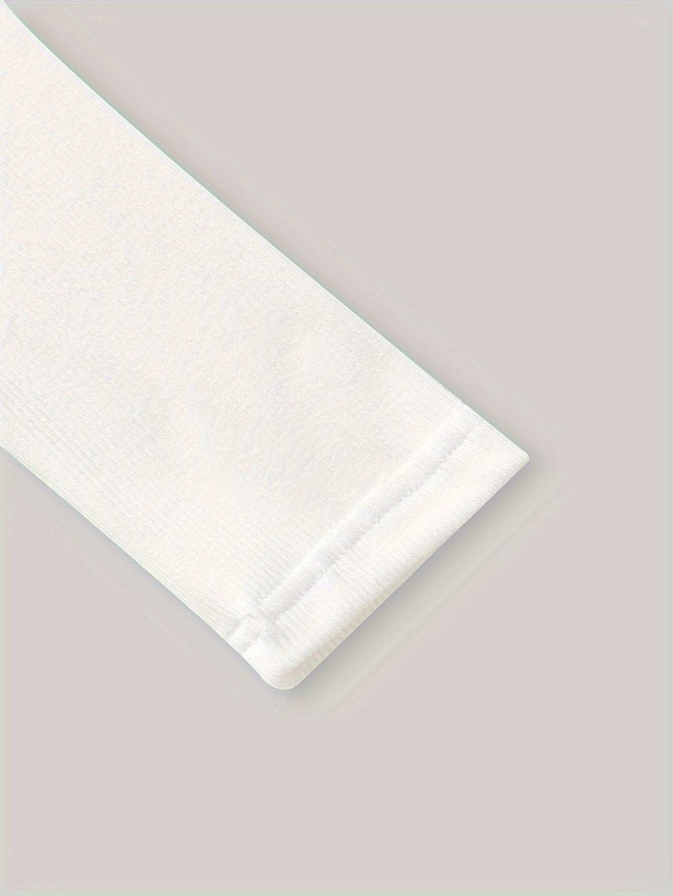 Close-up of a white long sleeve from a fashionable two-piece dress.