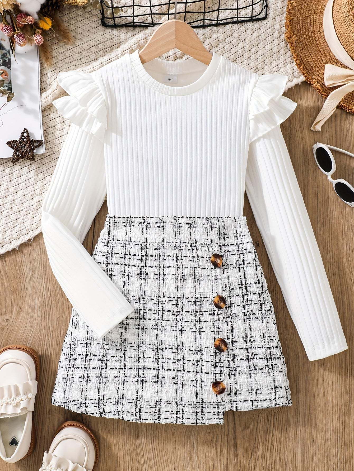 2-piece set with flounce trim long sleeve top and tweed knit skirt displayed on wooden surface.