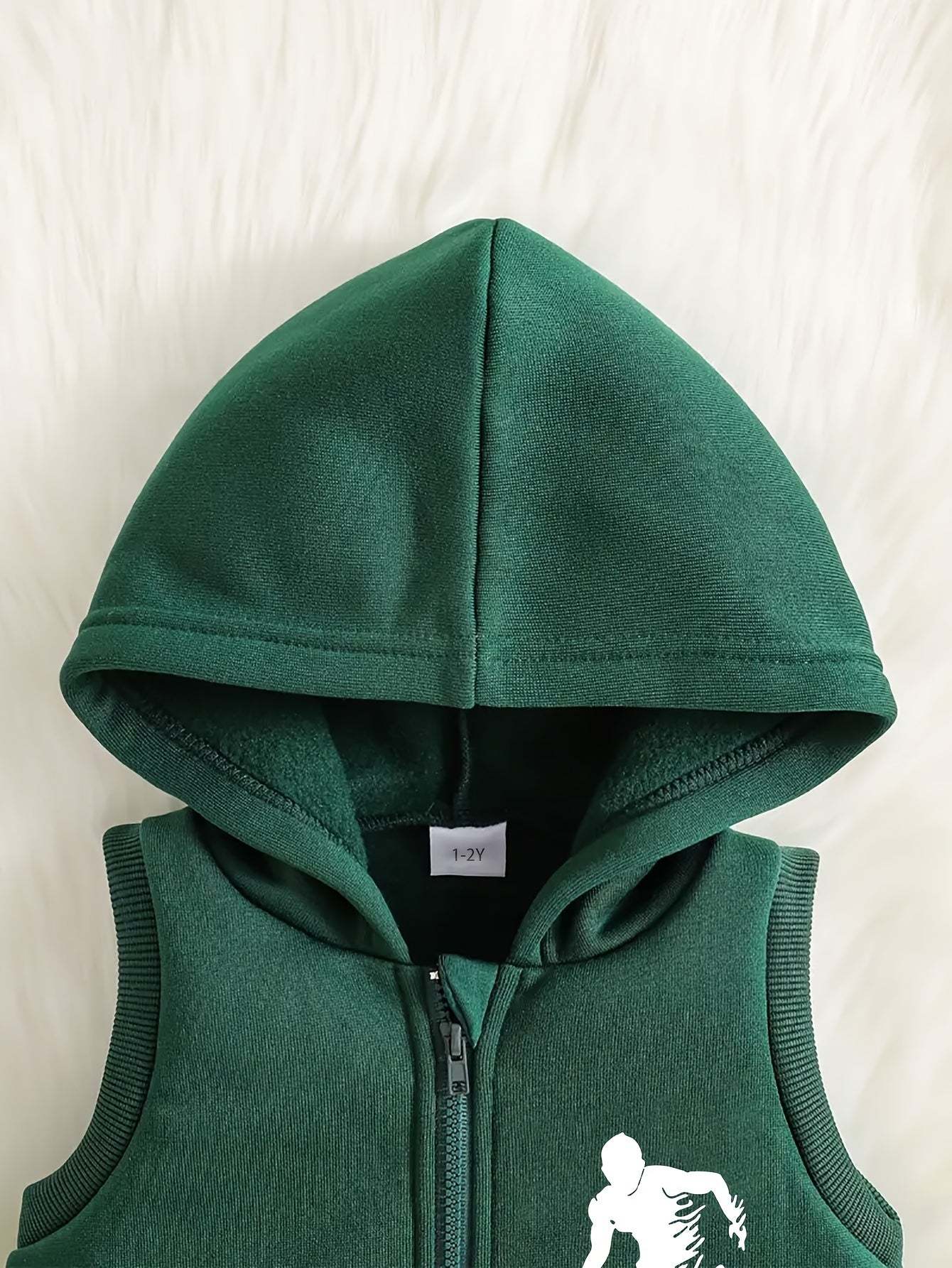 Sporty three-piece boys' set with soccer player design, green hooded top, polyester fabric.