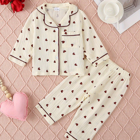 Adorable heart-patterned pajama set for girls, made from soft cotton with vibrant heart designs.