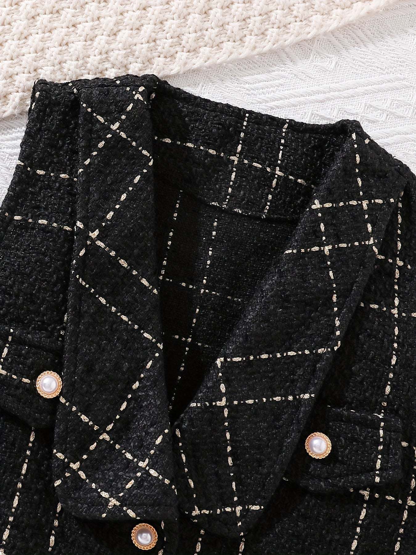 Trendy Girls' Outfit with cozy black plaid design for fall.