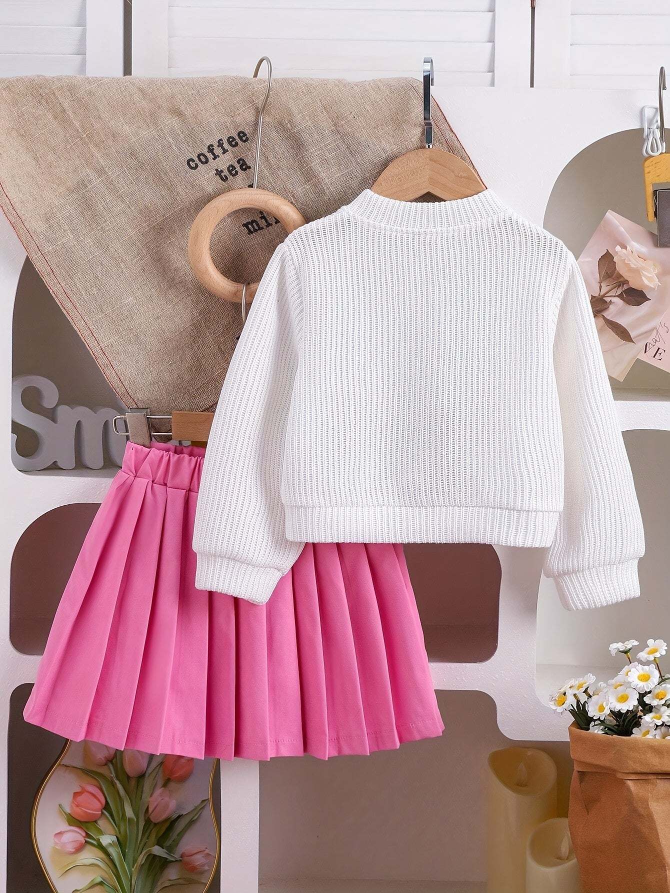 Adorable girls' outfit set with pink skirt and white top.