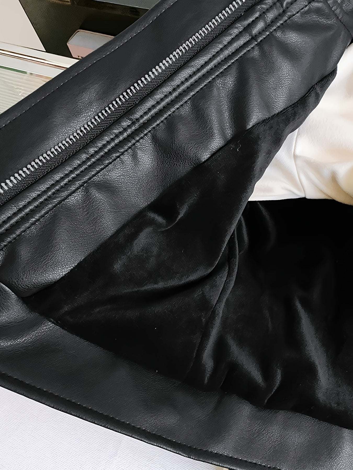 Inside view of the trendy leather jacket for girls, highlighting the soft polyester lining and durable PU material.
