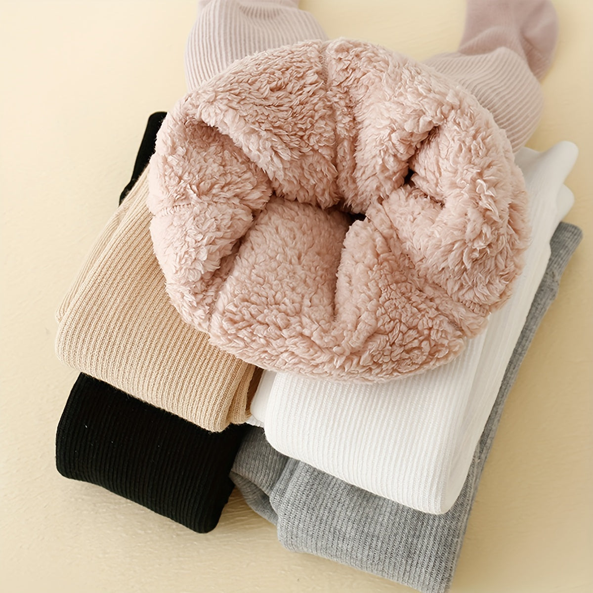 Cozy fleece-lined girls' tights in assorted colors for winter wear.