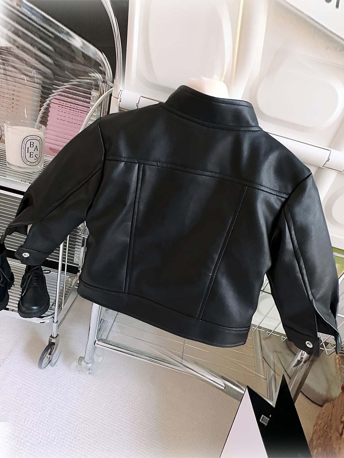 Trendy leather jacket for girls with black solid color, long sleeves, and stand collar.