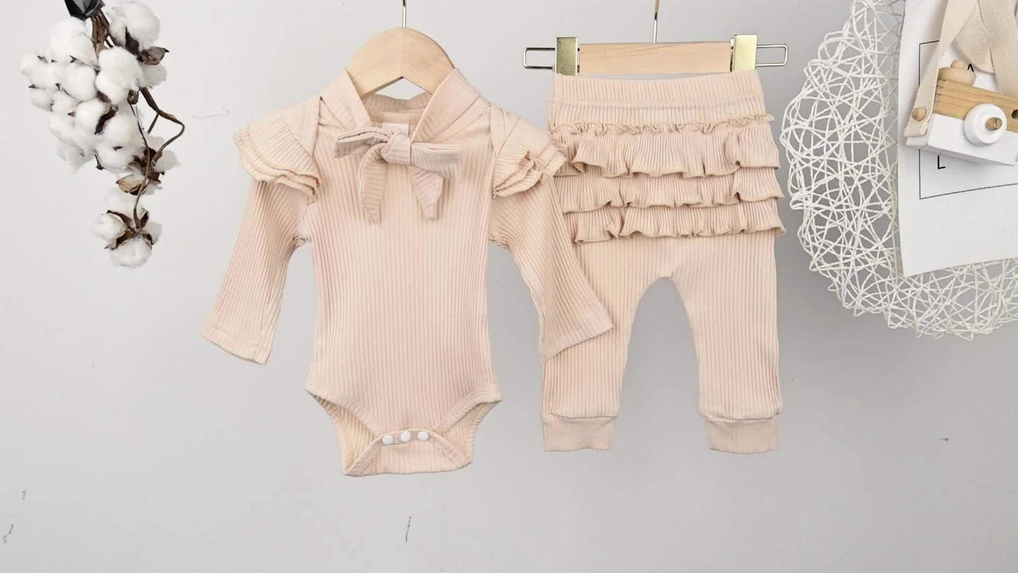 Charming Trio 3-piece outfit set for girls with ruffled top, matching pants, and headband.