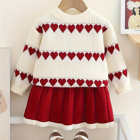 Adorable heart-patterned kids' outfit with sweater and skirt in red and white.