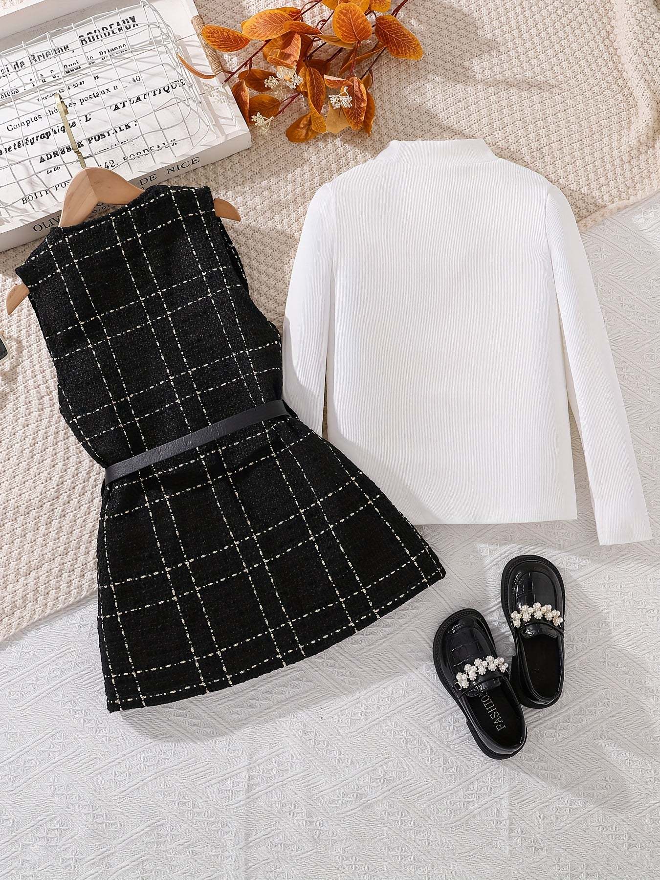 Trendy girls' 2-piece fall outfit with plaid dress and white long-sleeve top.