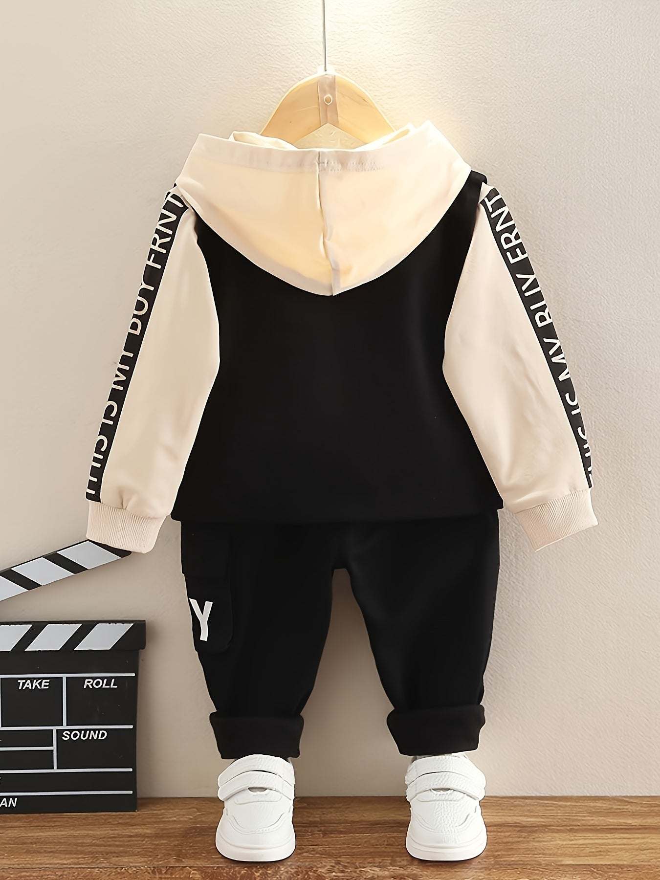 Trendy boys' three-piece set with bold 'Boy' design, black and cream hoodie and pants ensemble.