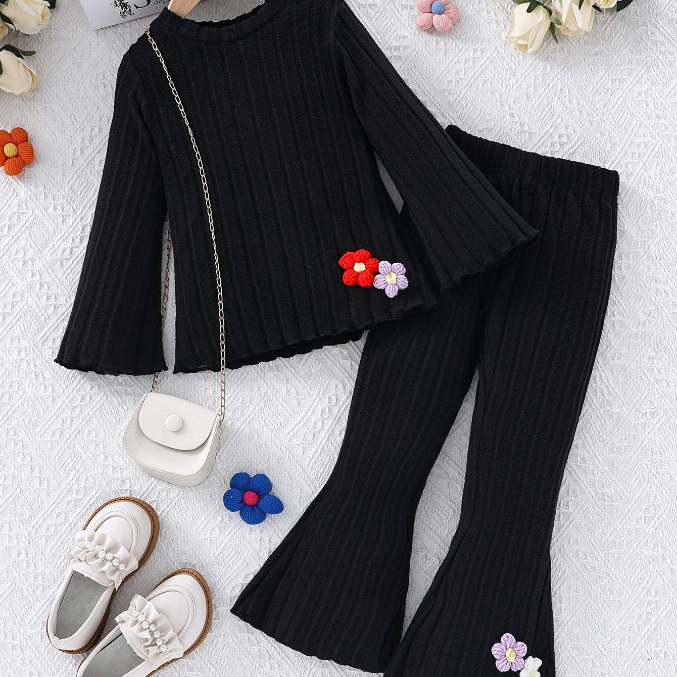 Stylish girls' black outfit set with long-sleeve top and pants, featuring colorful flower accents.