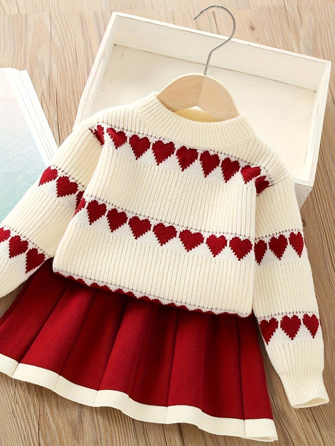 Adorable heart-patterned kids' set with red hearts and pleated skirt.