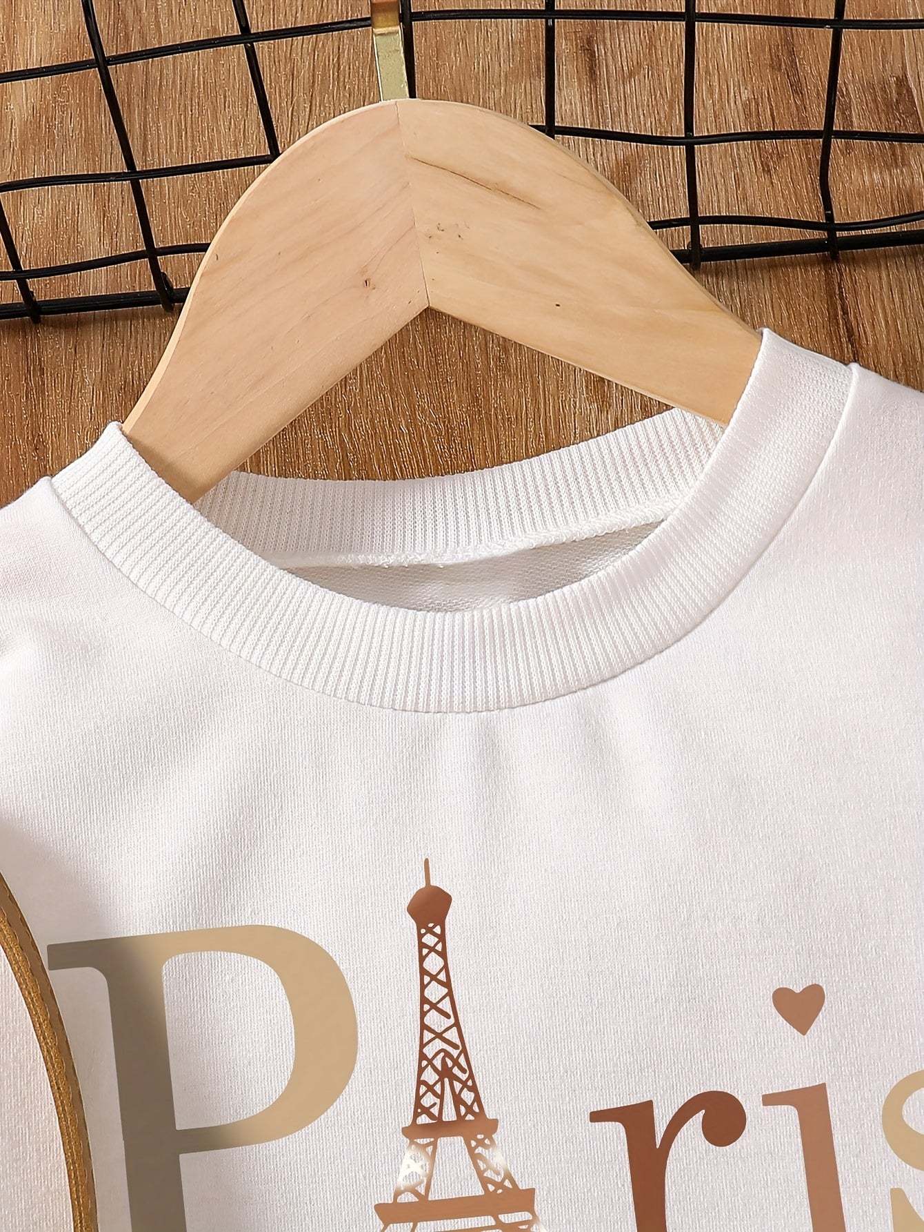 Chic girls' sweatshirt dress with Paris design and ribbed crew neck.