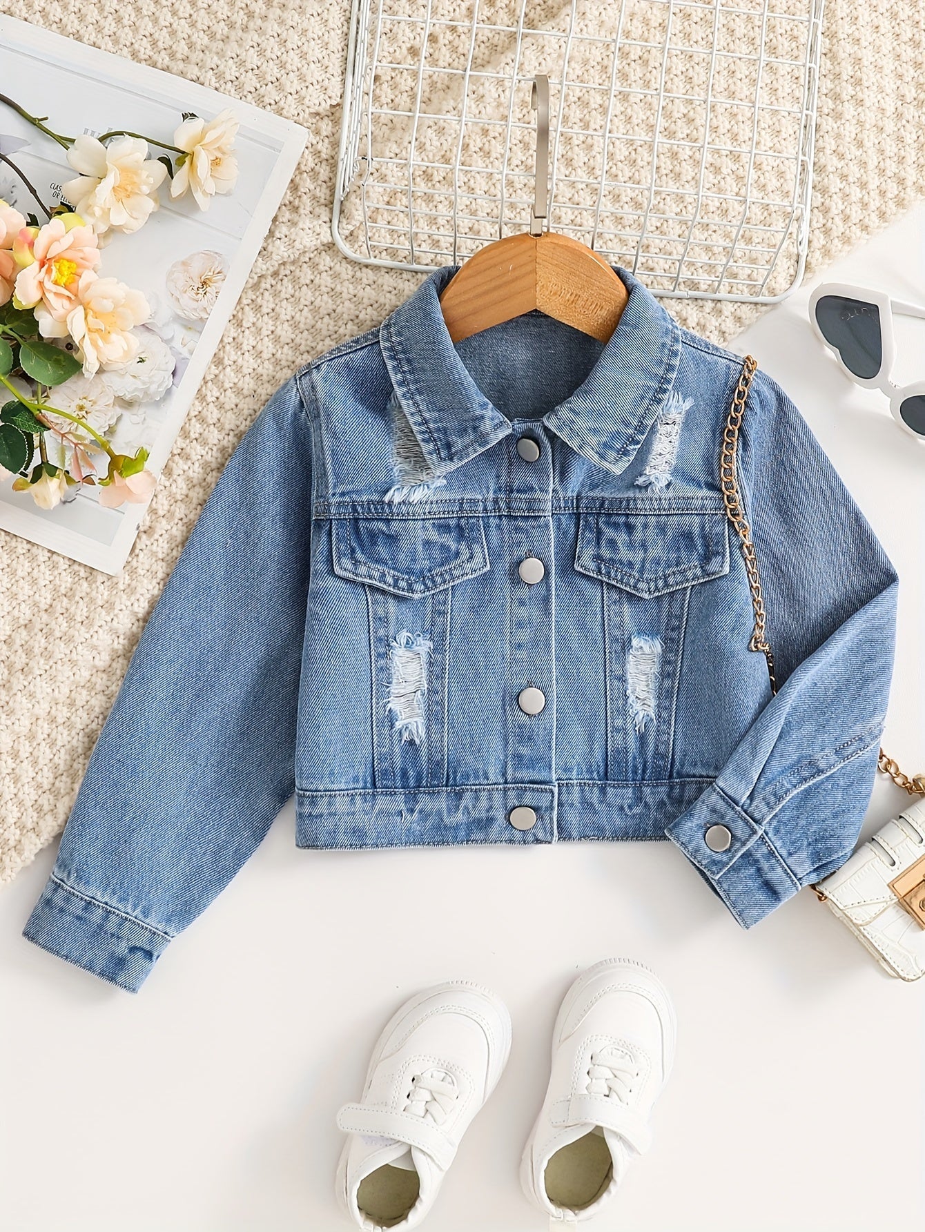 Fashionable girls' denim jacket with lapel collar and button placket, perfect for spring and fall layering.