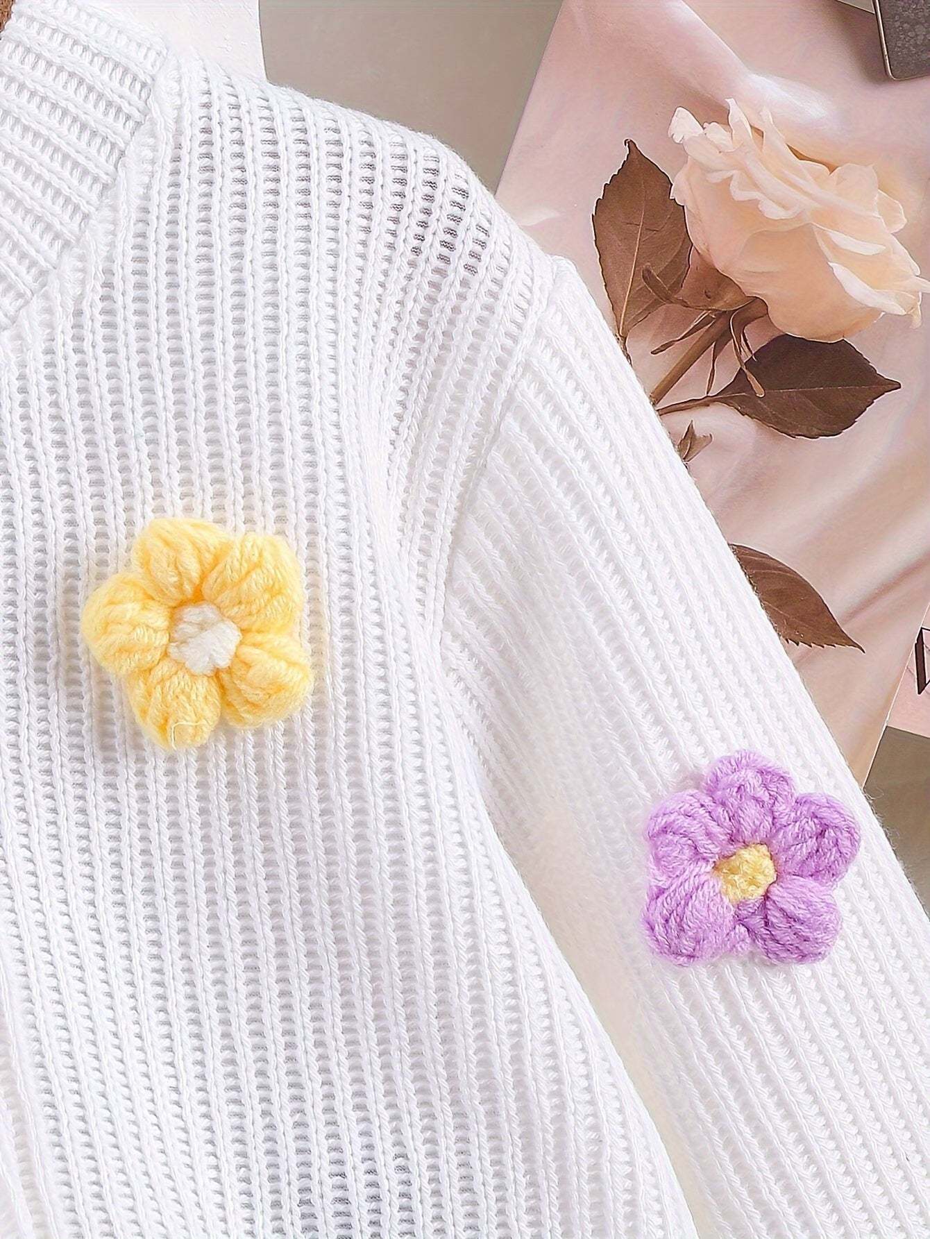 Adorable girls' outfit set with floral applique details on a white top.