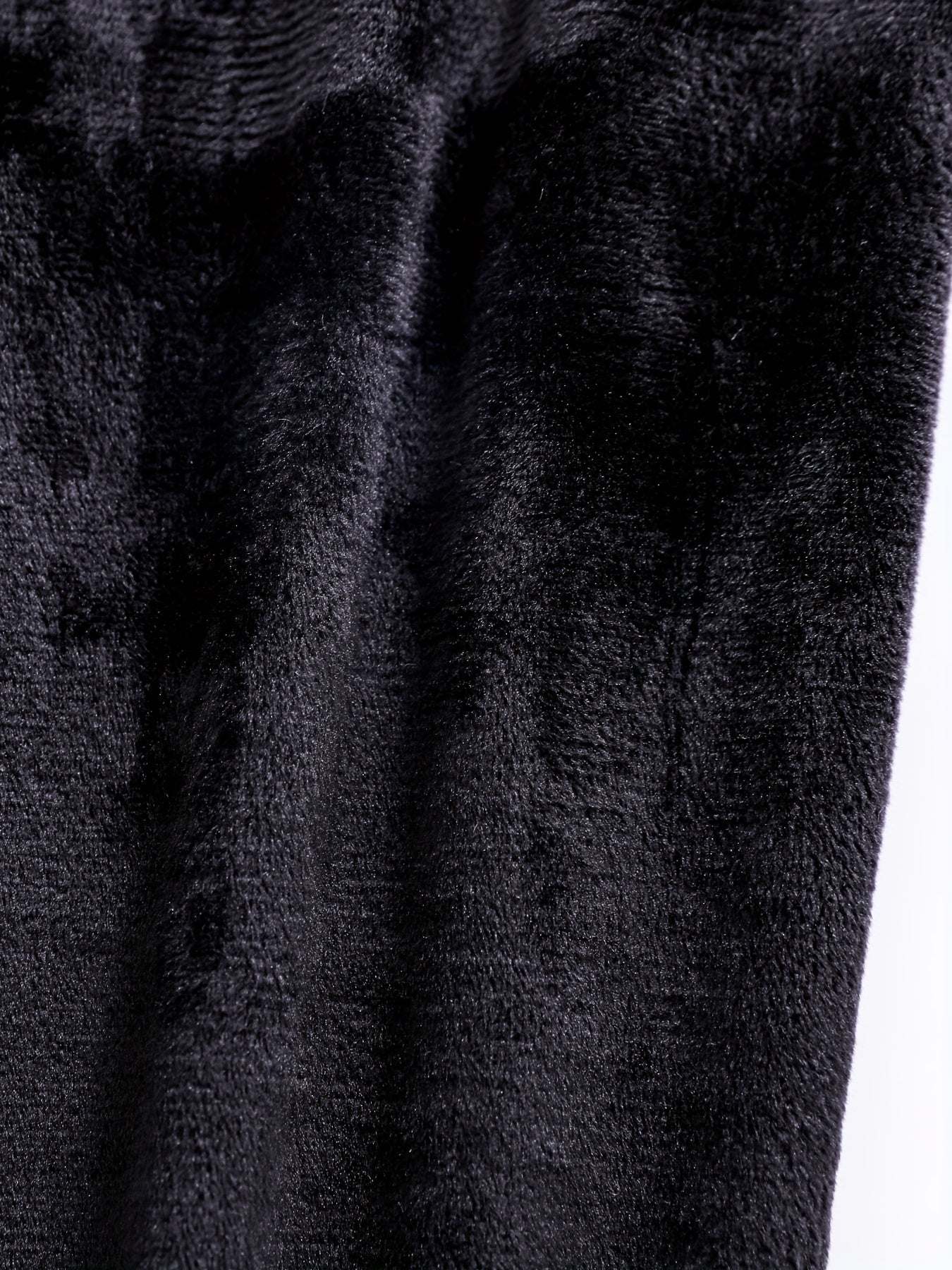 Classic black leather texture, showcasing the durable material of the boys' leather jacket.