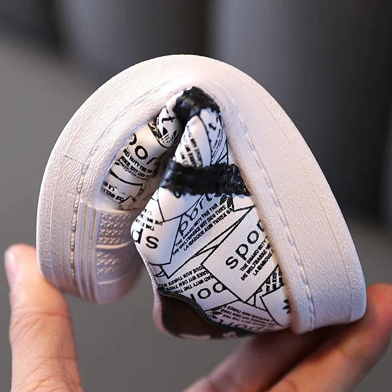 Playful safety anti-slip kids' shoe showcasing flexible sole with geometric pattern.