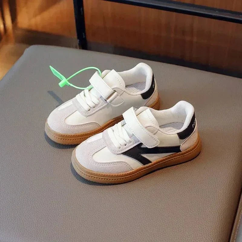 Trendy unisex sneakers for kids with durable PU leather and anti-slip sole.