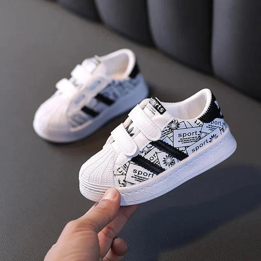 Anti-slip kids' shoes with durable leather upper and geometric pattern for playful safety.