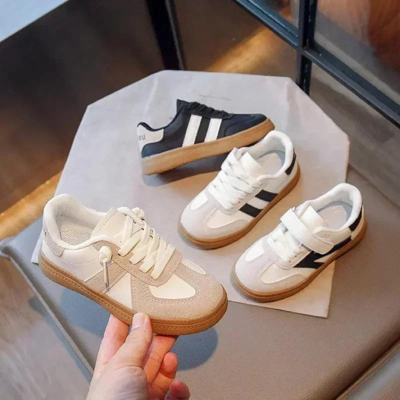 Trendy unisex sneakers for kids in white and black, designed for all-day comfort and durability.