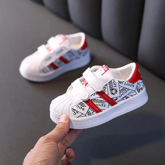 Playful safety anti-slip kids' shoes with red accents and geometric pattern.