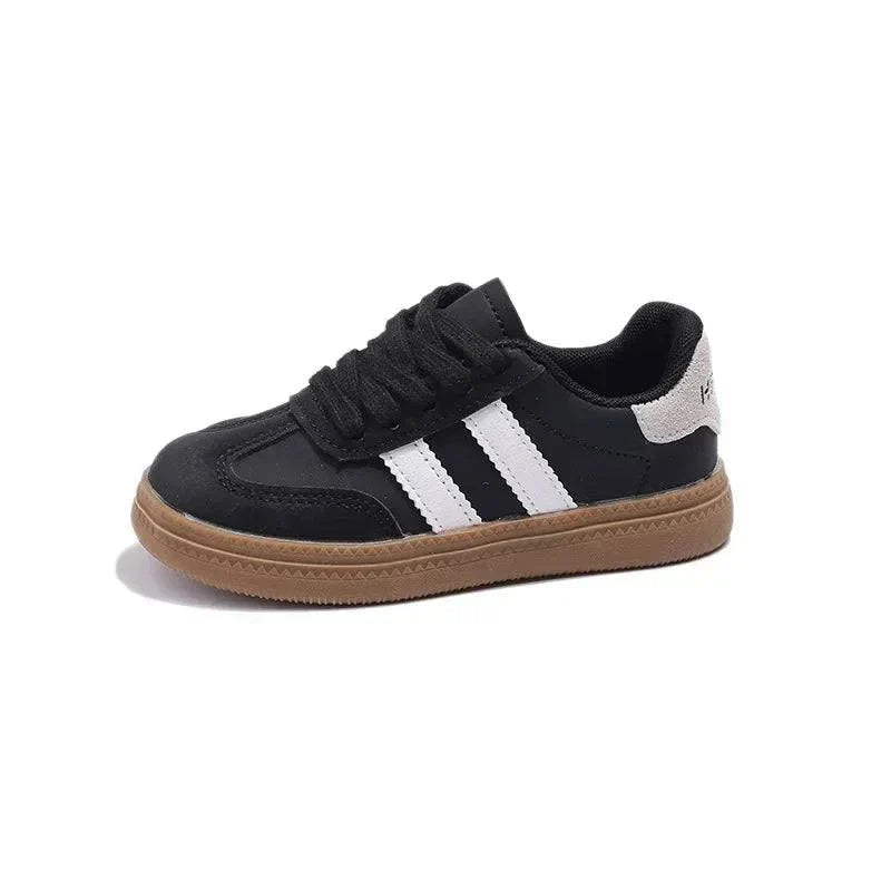 Trendy unisex kids' sneakers with black and white design for all-day comfort.