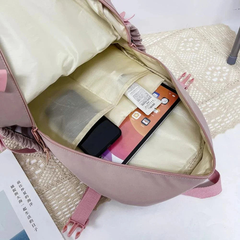 Pink schoolbag for children with spacious interior and organized compartments.