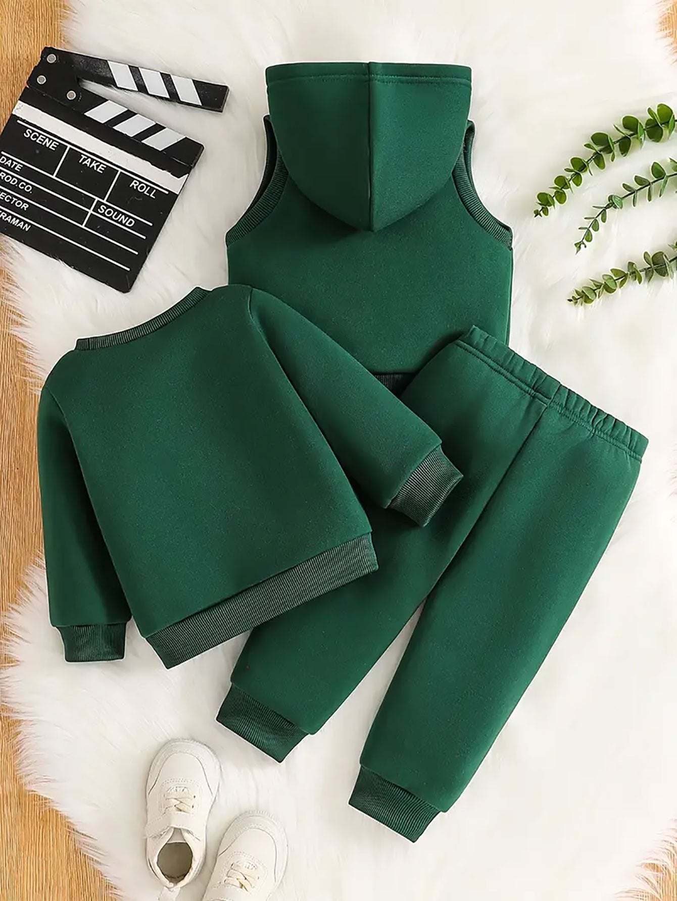 Sporty three-piece boys' set with soccer player design in green.