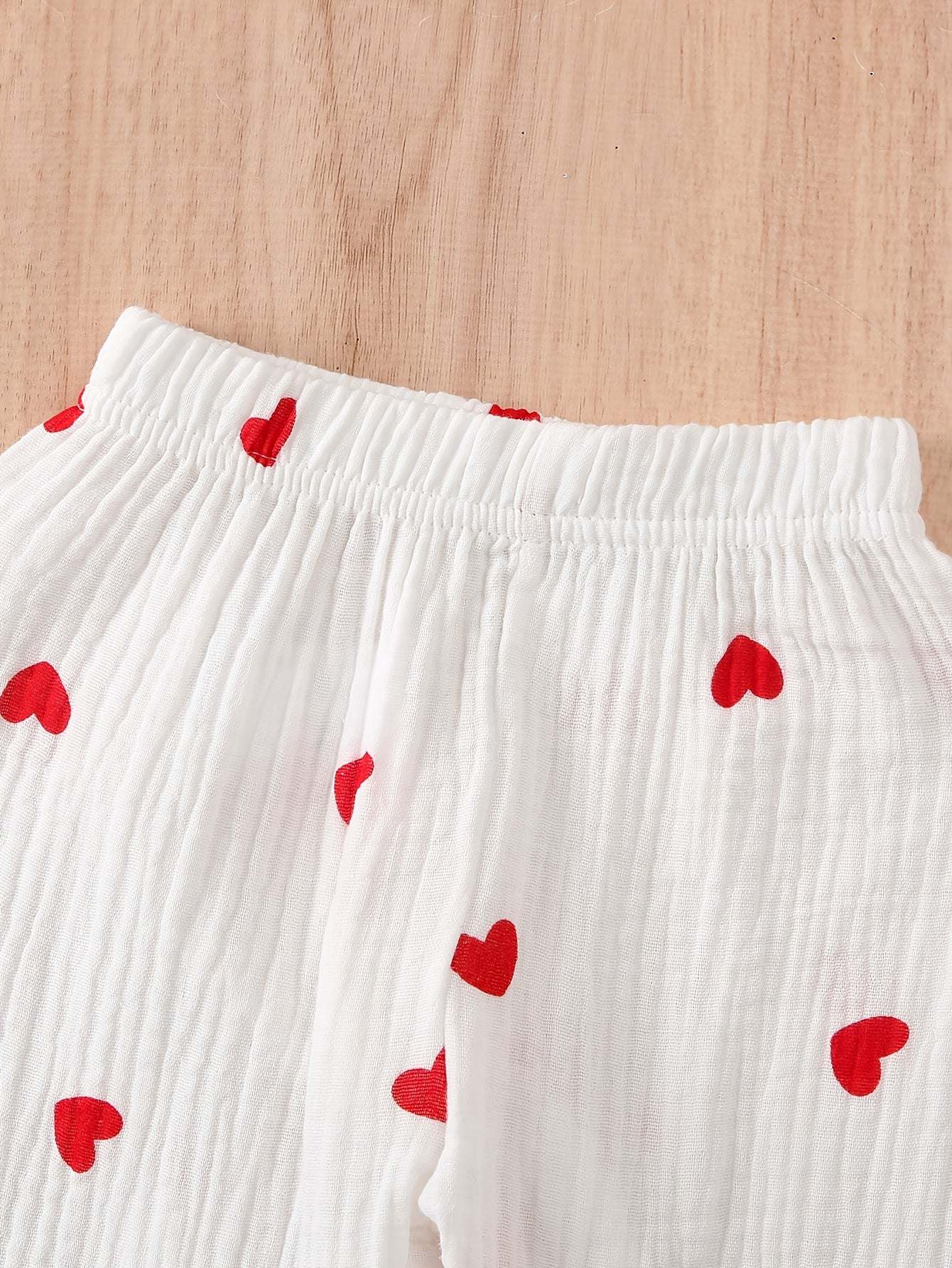 Adorable heart-patterned cotton pajama set for girls.