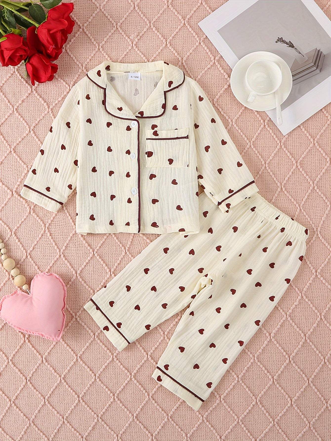 adorable heart-patterned pajama set for girls with red hearts on soft cotton fabric, ideal for bedtime comfort