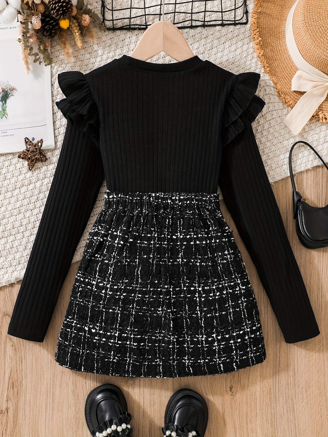 2-piece set with flounce trim long sleeve top and tweed knit skirt displayed on a hanger.