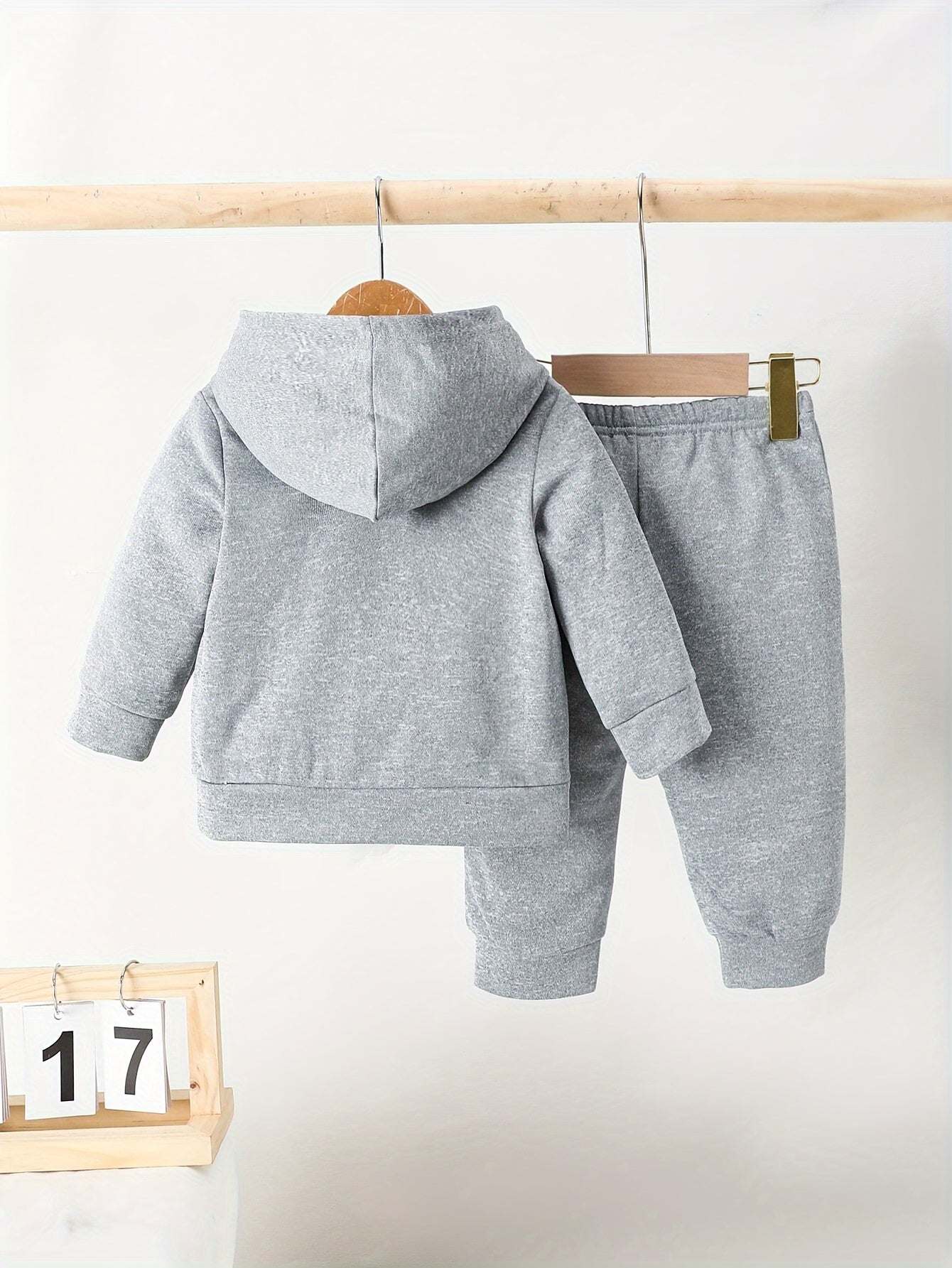 Trendy boys' California print outfit set with gray hooded sweatshirt and pants, displayed on a hanger.