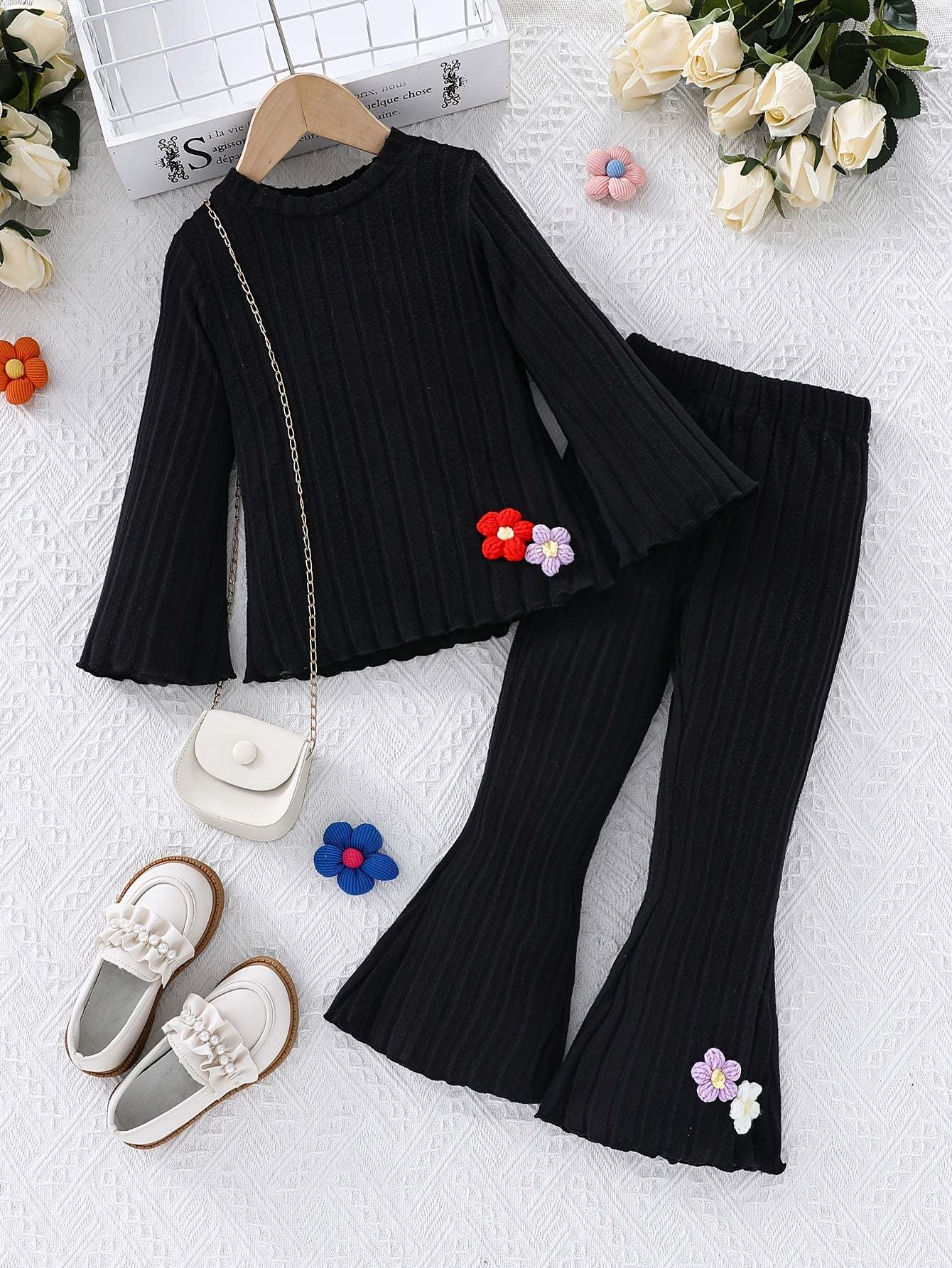 Stylish girls' outfit set in black with floral accents, featuring a high-quality polyester knit for a refined, minimalist look.