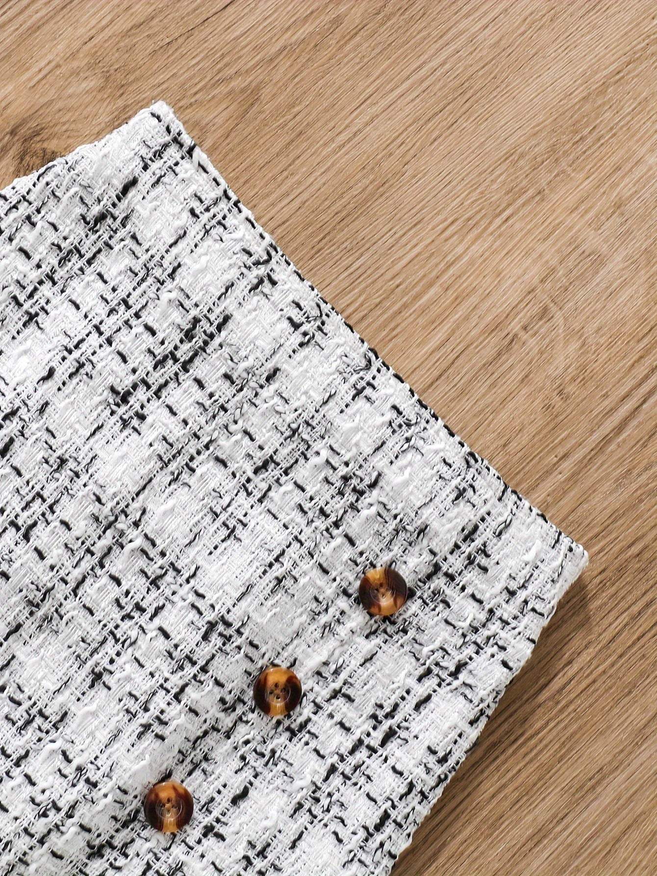 Close-up of tweed knit skirt from 2-piece set showing detailed texture and button accents.