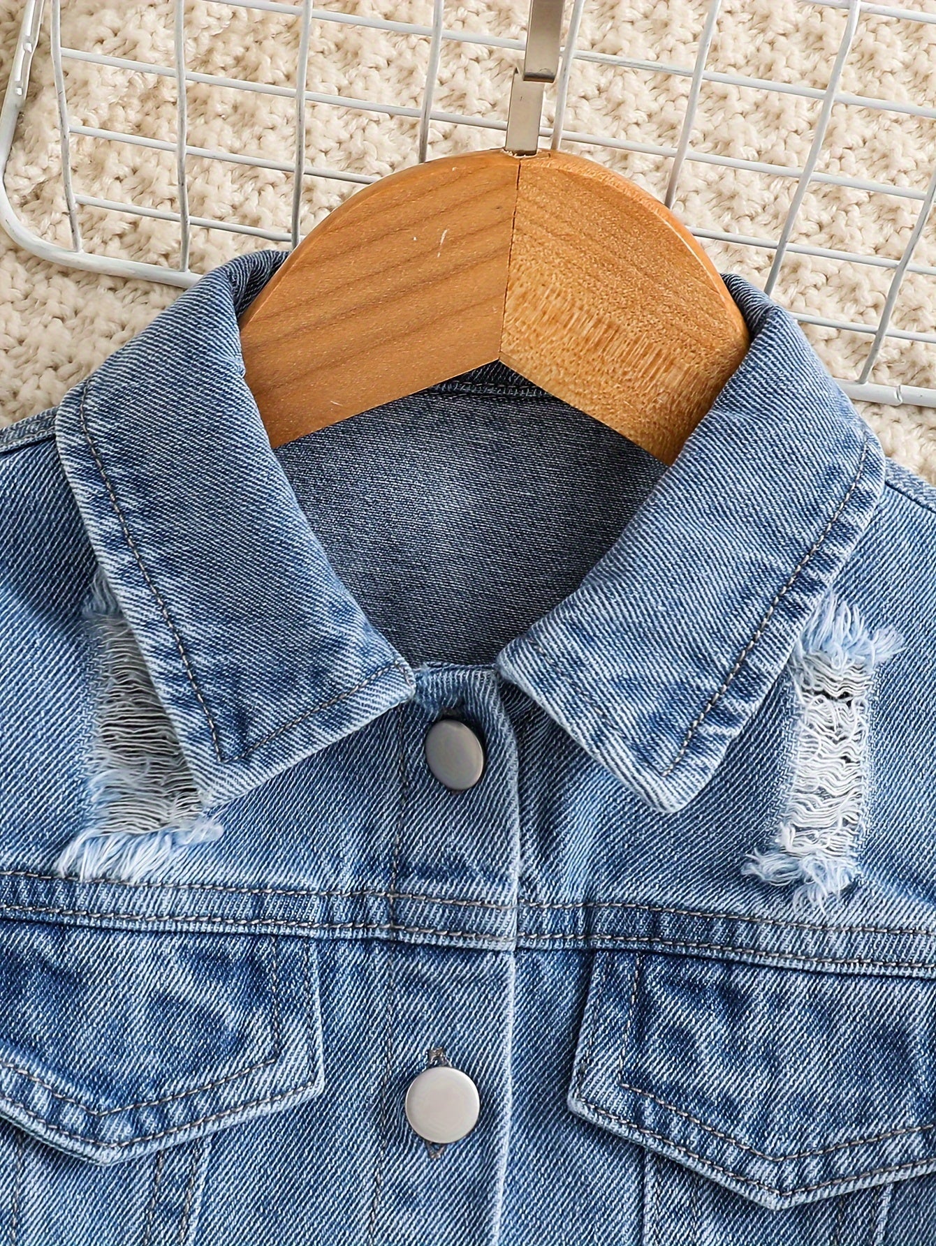 Fashionable girls' denim jacket with lapel collar and distressed details.