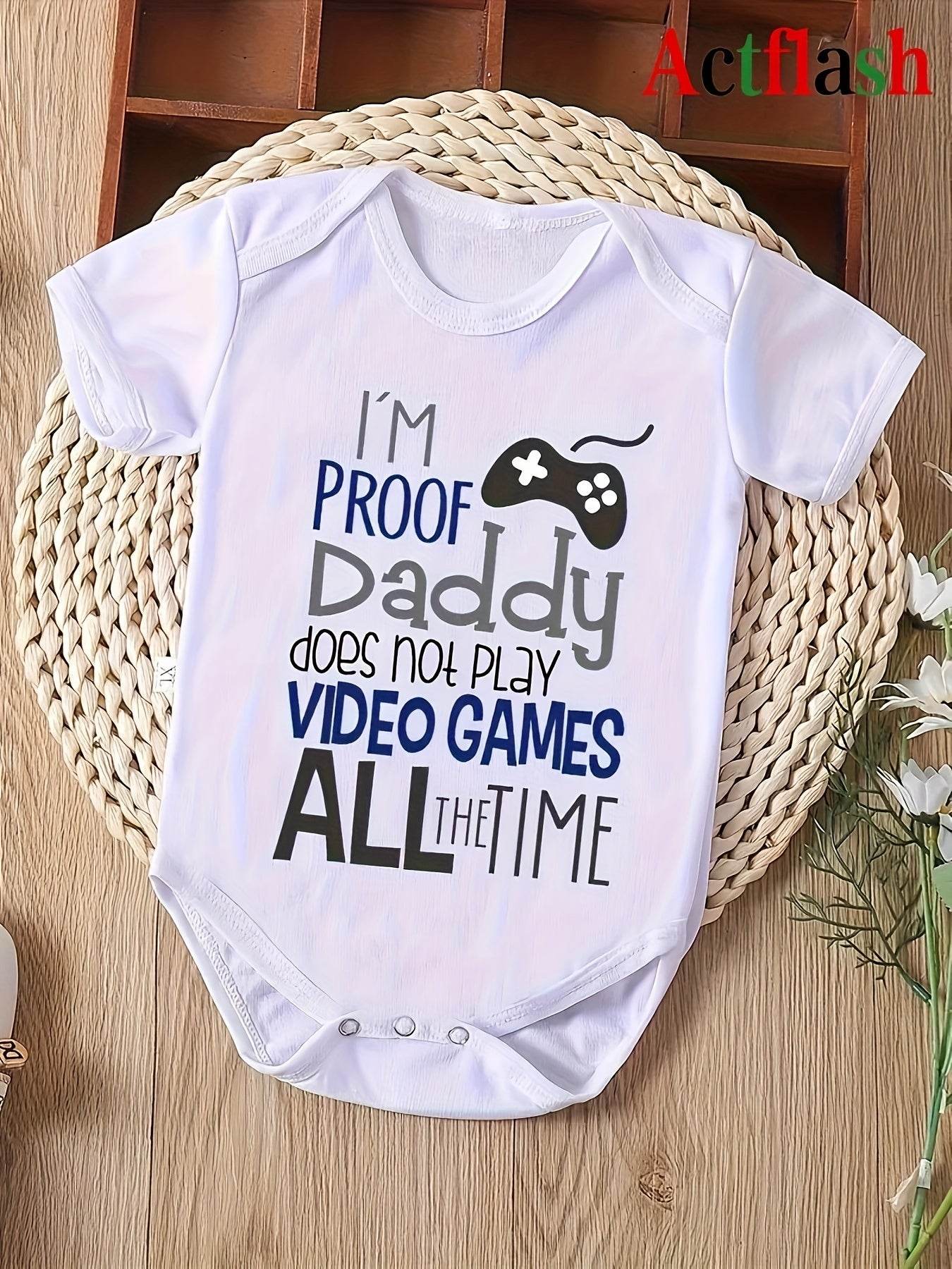 Infant romper with "I'm Proof Daddy Does Not Play Video Games All the Time" humorous statement design.