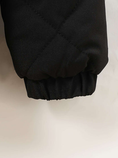 Close-up of a chic velvet hooded jacket sleeve in black, perfect for trendy layering.