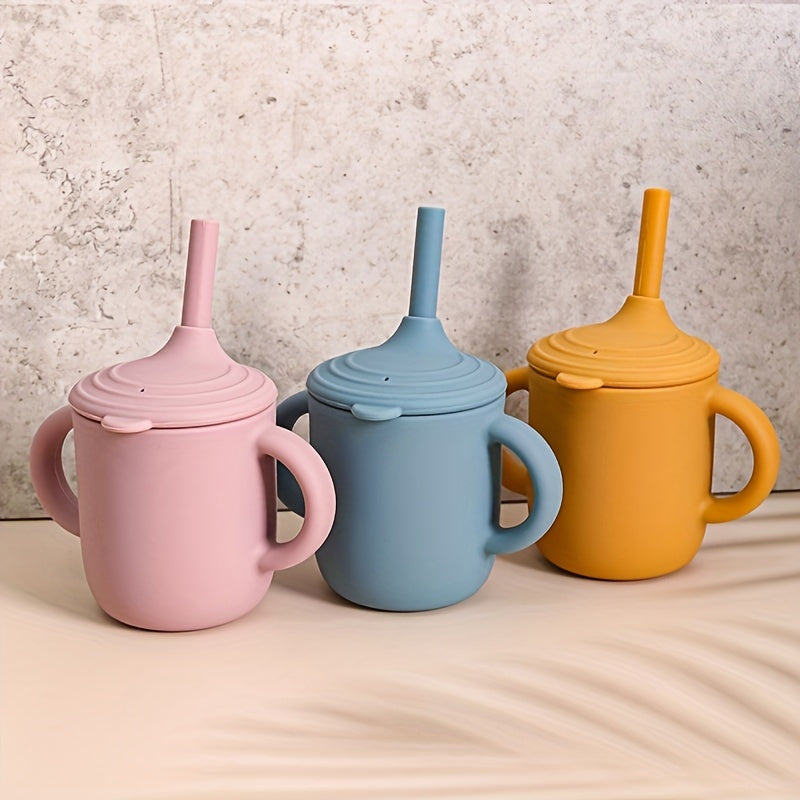 Easy grip double handled cups in pink, blue, and yellow for kids' independent drinking.