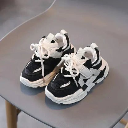 Safe Steps anti-slip sneakers for toddlers aged 1-3 years, black and white design.