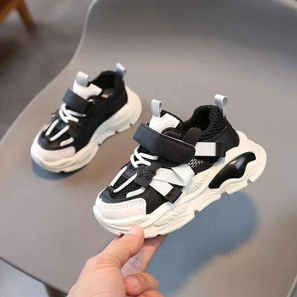 Safe Steps anti-slip sneakers for toddlers, black and white design, ideal for children aged 1-3 years.