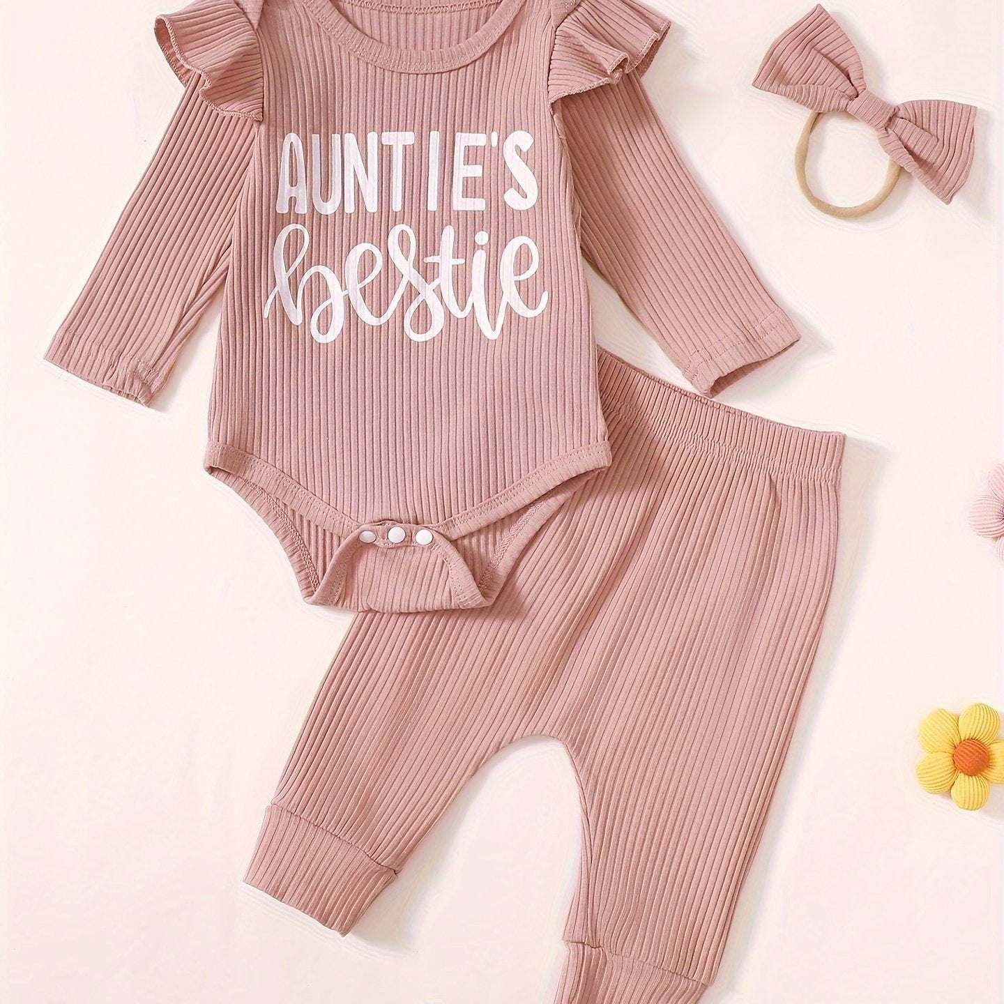 Cute baby outfit set with "Auntie's Bestie" print in soft cotton, includes onesie, pants, and matching headband.