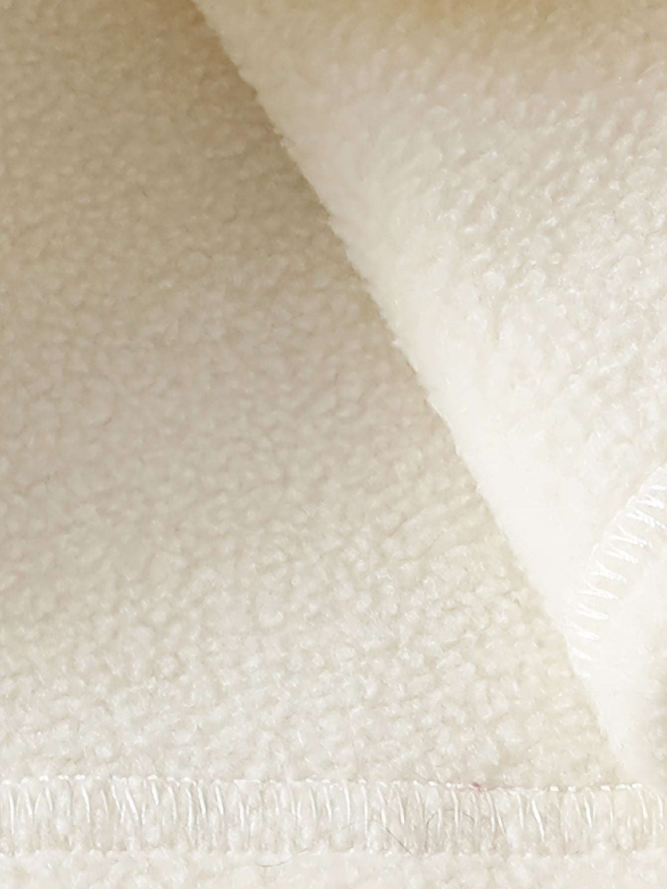 Close-up of soft, textured fabric used in a baby girl's stylish and comfortable outfit set.