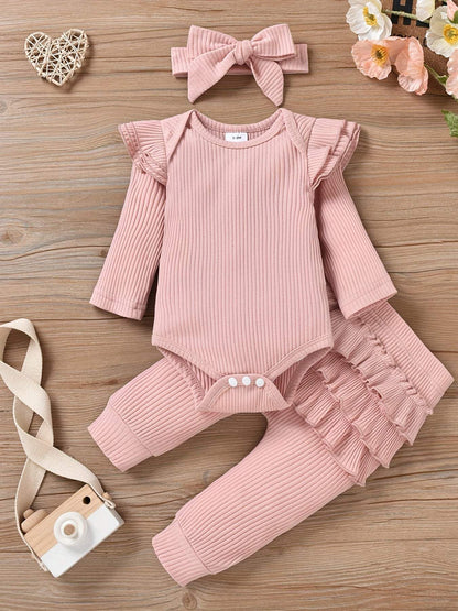 Charming Trio 3-piece outfit set with headband for girls, featuring soft pink long-sleeve top, matching pants, and headband on wooden background.